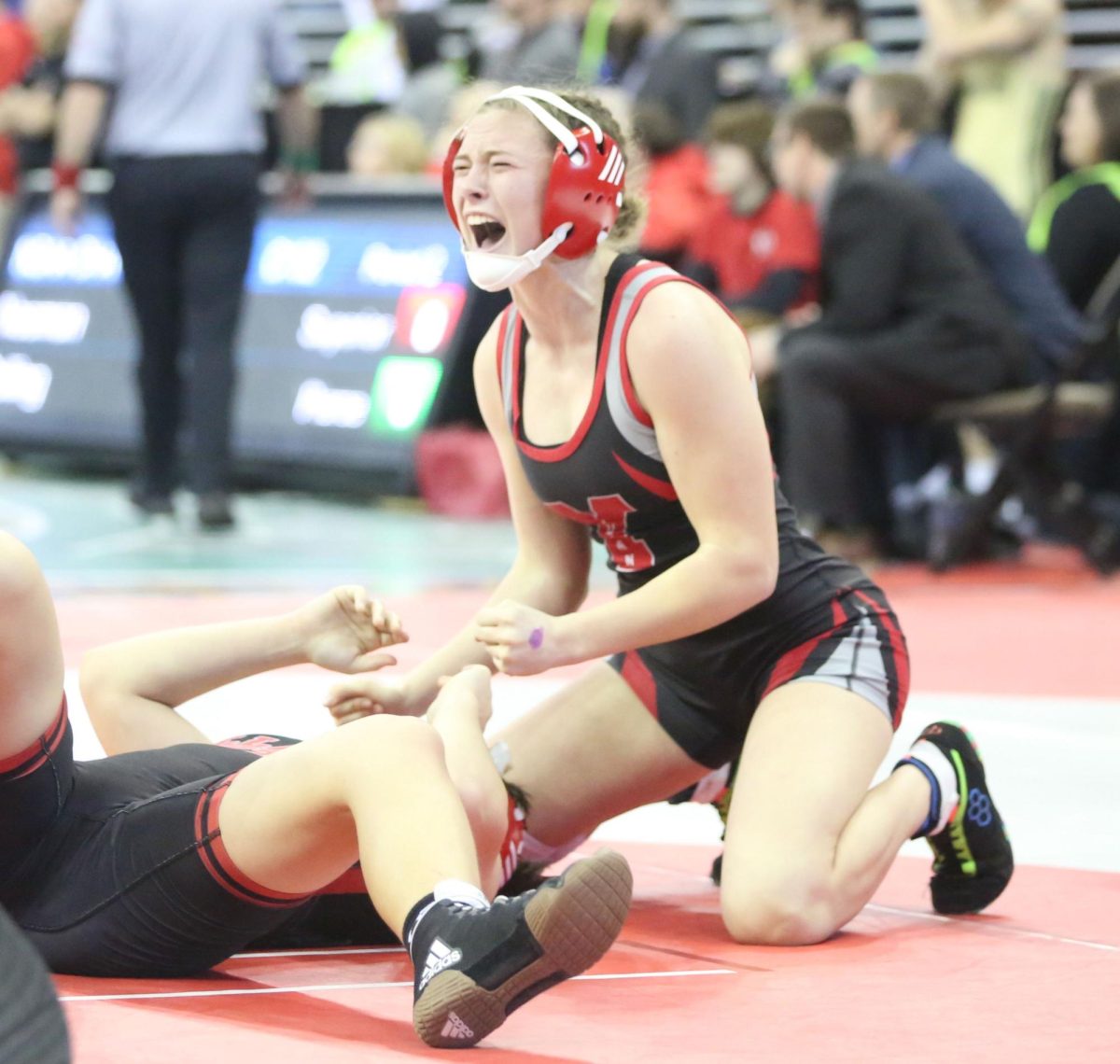 In her fifth place match at state last year, Jordyn Campbell celebrates after winning with a pin. Campbell set the school record of most pins in a season with 47.