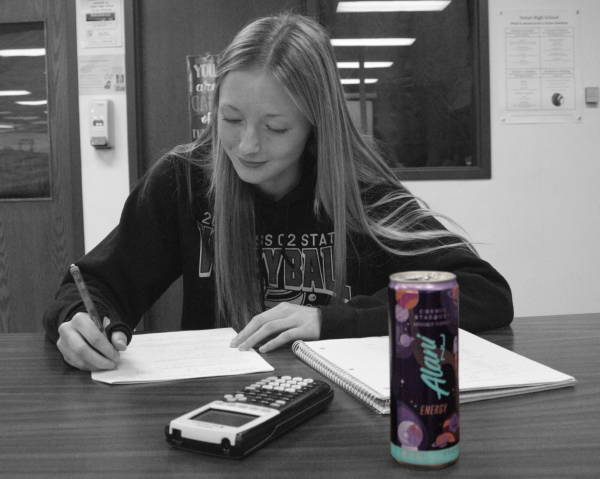 Junior Mckenna Jones completes homework after drinking an Alani energy drink. According to a recent survey, about one-third of Yutan students drink an energy drink at least once a day.