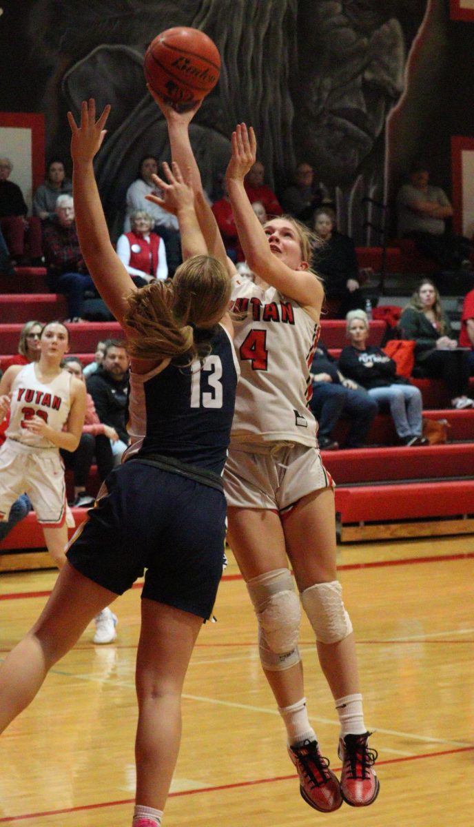 Junior Jade Lewis reaches over a Raymond Central opponent to score a layup. Jade had a total of seven steals in the second conference game. 