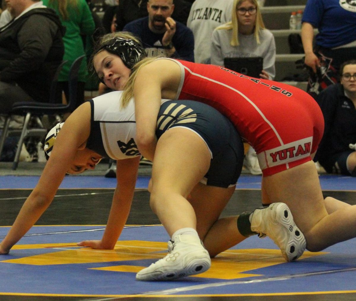 Nicole wrestles with an opponent during a match. Wacker is currently in her second year of wrestling.