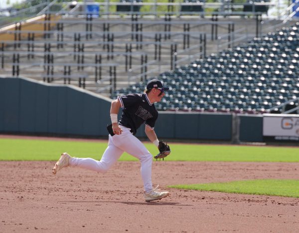 Senior Braxton Wentworth charges after a ground ball during the state game last season. Wentworth has been starting shortstop since his junior year.