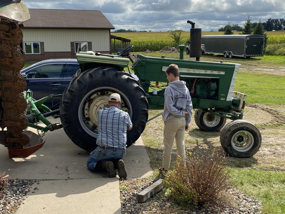 Senior Gavin Fenn assists at fixing a tractor tire. In Fenn’s future career as a diesel truck and tractor trailer driver he will have to learn how to fix different parts of the vehicles.
