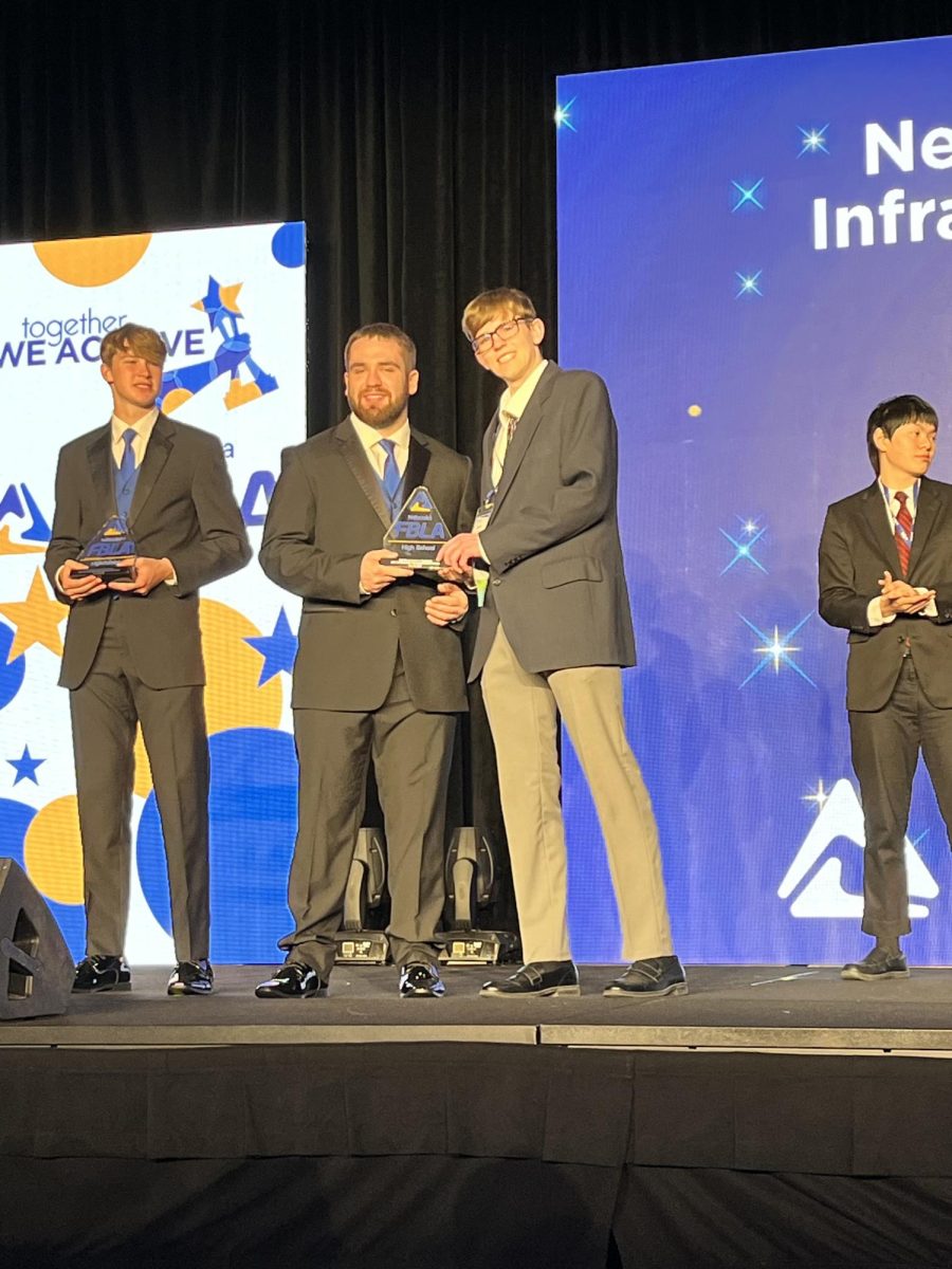 Senior Bryce Kolc accepts trophy after placing second in Networking Infrastructures. This was the first time Kolc competed in the event.