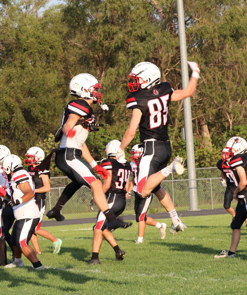 Sophomore Ryan Maguire goes up to celebrate with senior Max Egr before the annual gatorade scrimmage. Maguire currently participates in football and plans to take part in basketball and track.