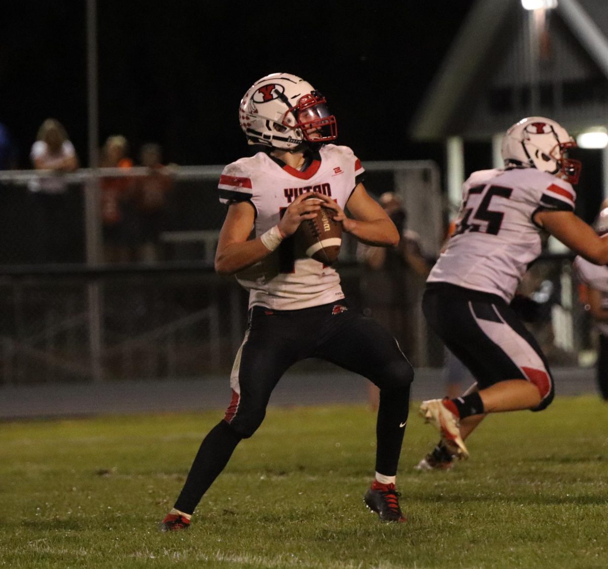 Sophomore Nathan Daniell looks to pass the ball to one of his teammates. At a game against Oakland-Craig, Daniell had 130 passing yards. 