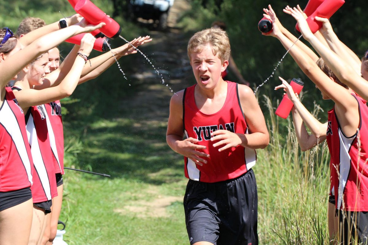 Freshman Liam Maloy strides toward the finish line. Maloy's favorite part of cross country is "being in the vans because it can be funny with [Mr.] Carrillo."