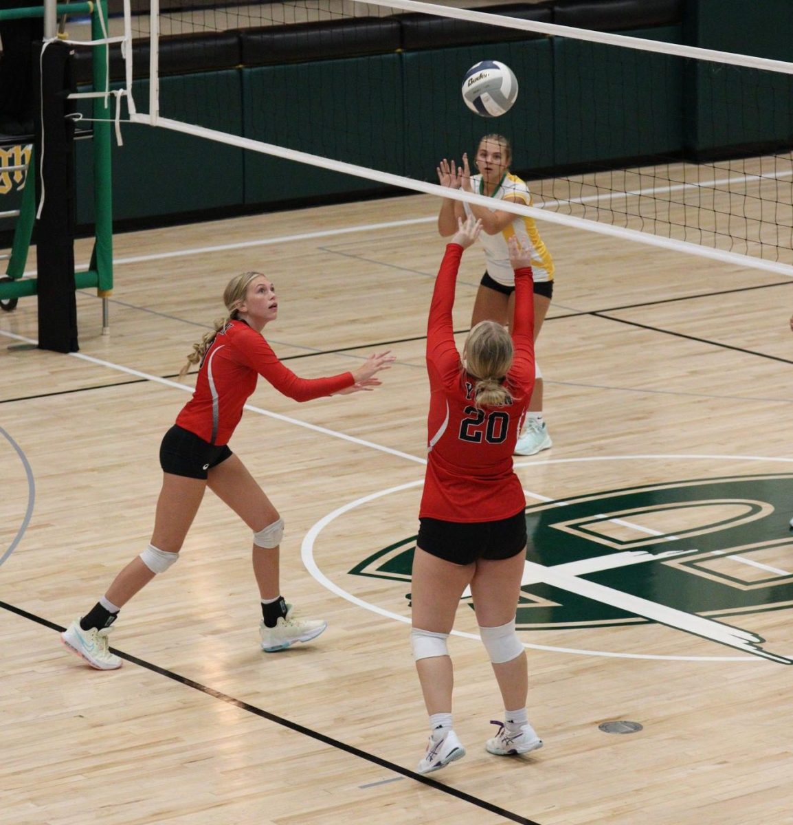 At Bergan, freshman Morgan Long sets the ball to freshman Jersey Daniels. This year, the volleyball team had enough freshmen players to create a reserve team. 