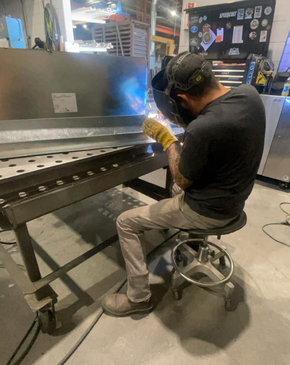 A specialty welder at MMC Contractors demonstrates precise welding. Mayne-Hernandez watched him weld a main part for a commercial building (Courtesy photo)