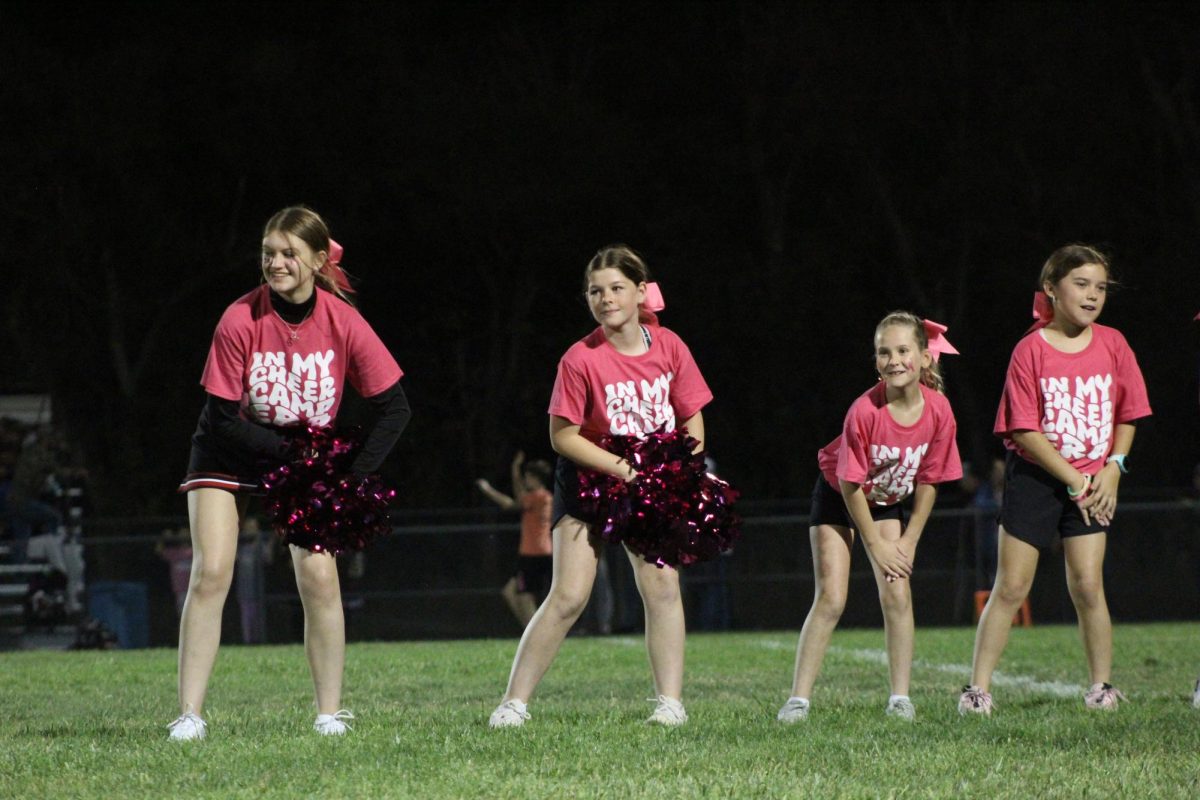 Senior Libby Winn leads the fifth and sixth graders through there dance camp. Winn helped adapt the dance moves to the elementary level.