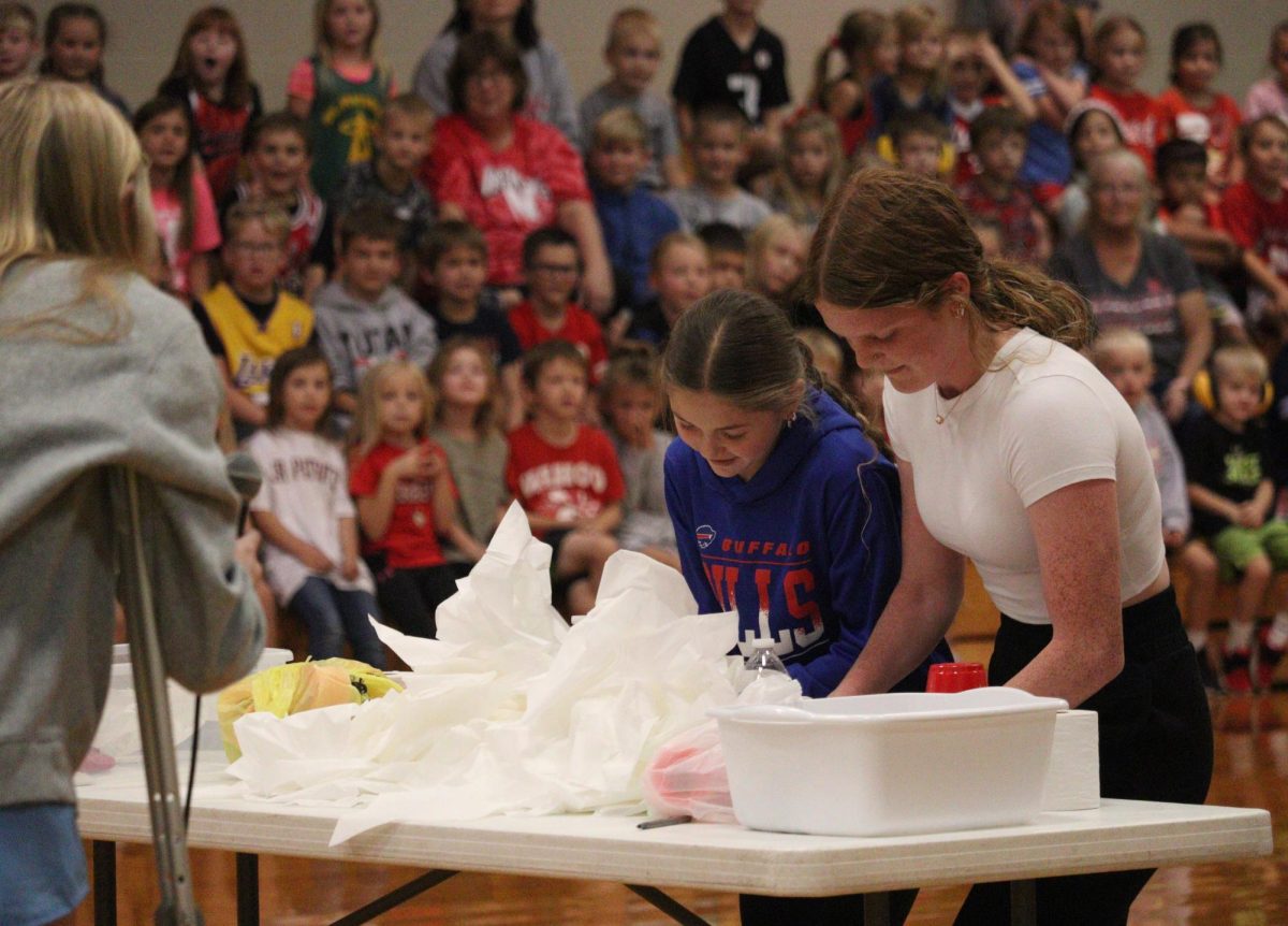 During the elementary pep rally, sixth grader Maggie Zeleny senior Aubrie Pehrson compete to pull tissues out of a box the fastest. Every year during Homecoming week, the seniors participate in minute-to-win-it games against the sixth graders. “It was exciting to hear all the elementary kids screaming in the crowd,” Pehrson said. “I had a lot of adrenaline as I was competing with Maggie.”