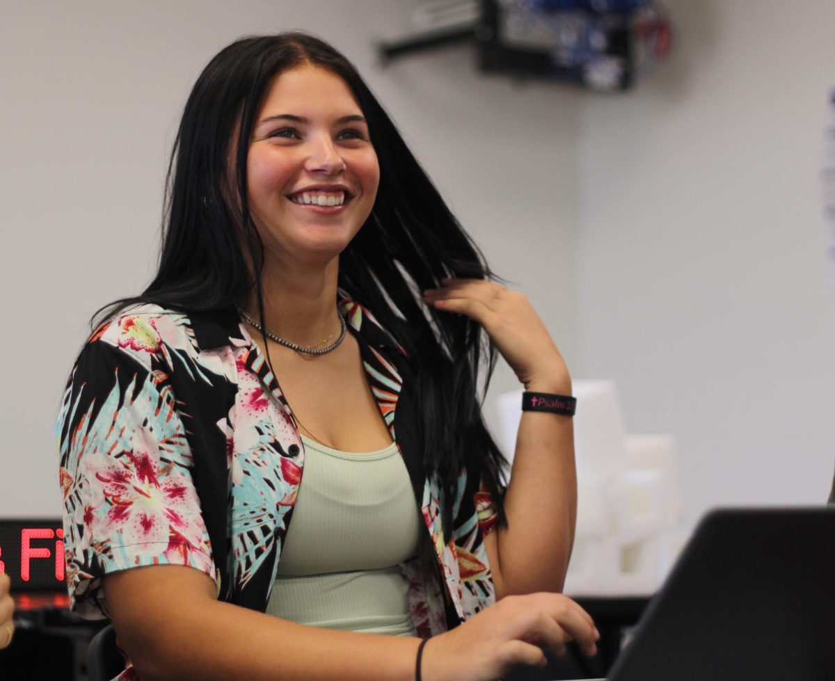 On Hawaiian Day, sophomore Amalea Vaughn-Lantzer laughs with her classmates in Personal Finance. Vaughn-Lantzer was one of 25 sophomores who dressed up that day. “Dressing up for HOCO gave me something to look forward to during the week,”  Vaughn-Lantzer said.