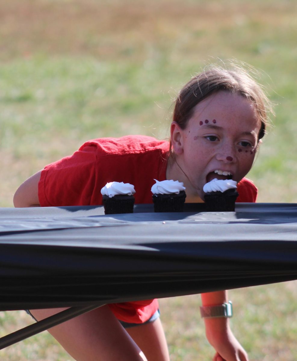 During the cupcake eating contest, seventh grader Daisy Freeman starts eating her first cupcake. Freeman was able to eat one out of the three cupcakes she was given. “My favorite part was getting to eat free cupcakes,” Freeman said. “I had so much fun.”