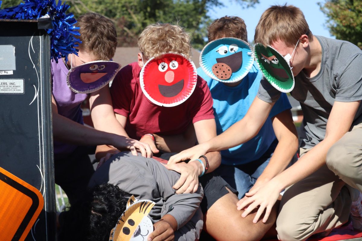 Dressed as Sesame Street characters, seniors Clark Cogdill, Tyler Witt, Owen Egr and Drew Krajicek tickle Wesley Patino on their homecoming float. The seniors placed third with their “Tickle the Tigers” float. “I wanted to be the one that got tickled because I thought it would be fun,” Patino said. “We were laughing the whole time, and it was a super fun experience.”