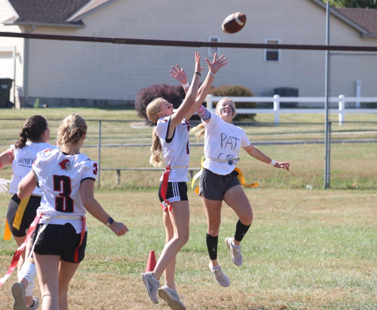 Senior Gabi Tederman and junior Olivia Chapman both reach to catch the ball during the powderpuff game. The juniors had ___   ____ against the seniors.