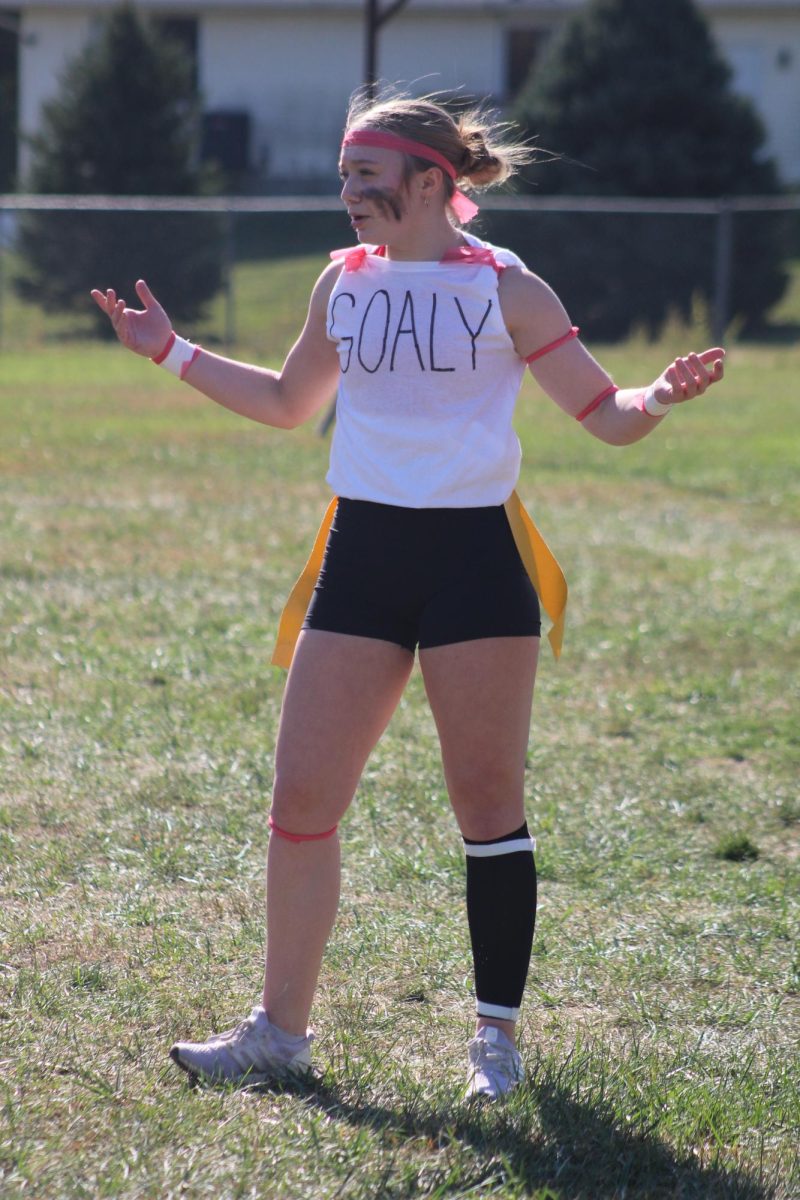 Junior Kylie Krajicek asks her “coach” a question during the homecoming powderpuff game. The juniors created their own jerseys with a nickname on the front and math equations as their numbers on the back. “We thought it would be funny to customize our own jerseys to make them more like us and represent our class,” Krajicek said.