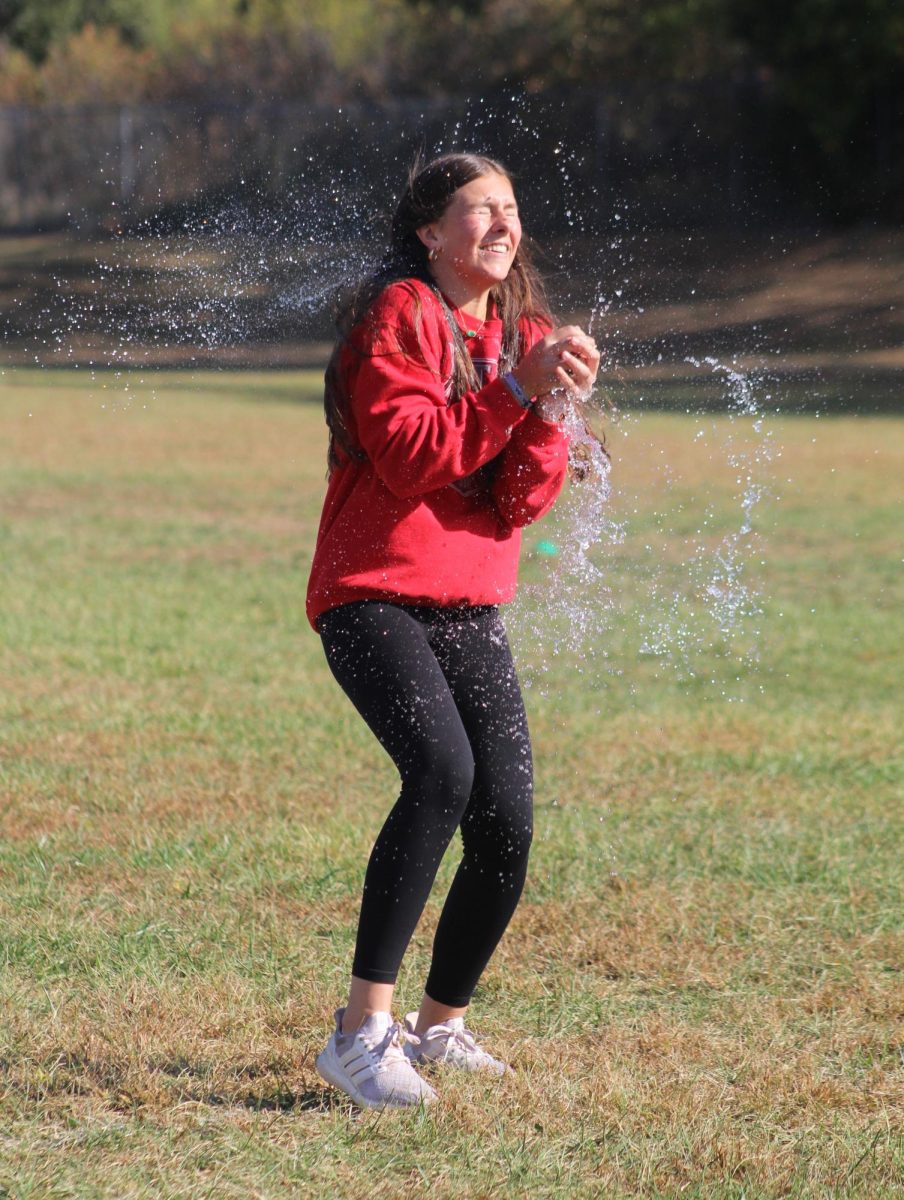 While participating in Chieftain Games, freshman Jersey Siske gets splashed as her water balloon pops. Siske and her partner, Addi Jones, got out in round three. “It was really fun to do the water balloon toss with Addi, but when it popped the water was really cold,” Siske said.