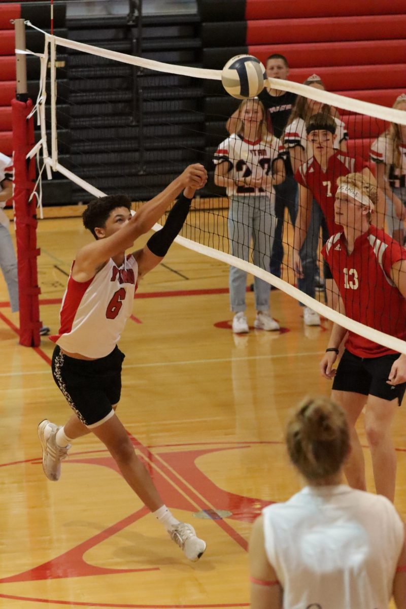 During the first annual powderbuff volleyball game, junior Derrick Seay passes the ball over the net to defender senior AJ Arensberg. The seniors won the first set of the game, while the juniors won the second set. “My favorite part was talking trash on the opponents with my teammates and the chants we did to break out the huddles,” Seay said. 