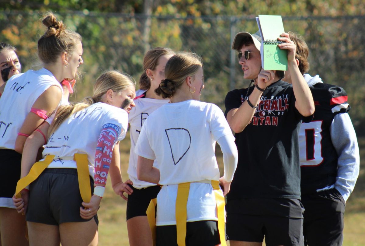 In the powderpuff football game, junior Carson Jurey shows the junior team a play. The juniors ended up winning 14-0 in the 15-minute game. “The girls didn’t know what they were doing, but we found a way to win the game,” Jurey said.