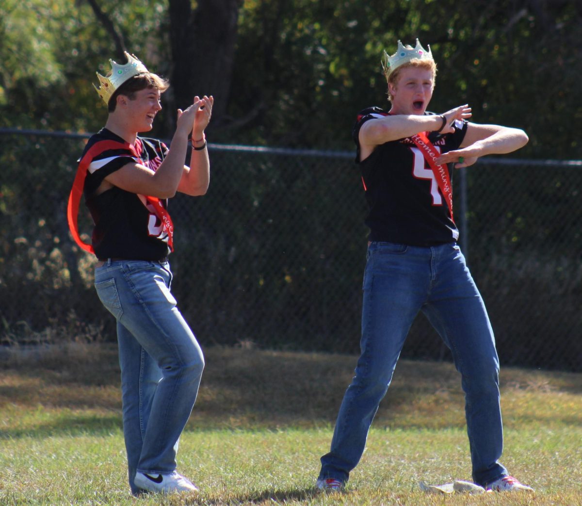 Seniors Bennett Ell and AJ Arensburg loudly cheer for the senior girls' powderpuff team. Ell and Arensberg, along with other seniors Max Egr and Tannen Honke, held multiple practices in order to prepare the senior girls for the game. “It was really fun practicing and showing the girls what to do when they had no clue what to do,” Ell said.