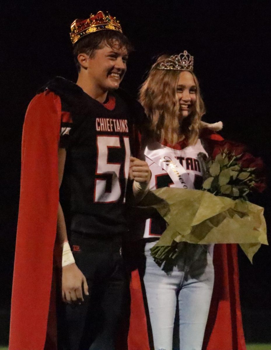 Seniors Bennett Ell and Britney Zeleny pose for pictures after being crowned homecoming king and queen. Zeleny's crown kept falling off but Ell fixed it.