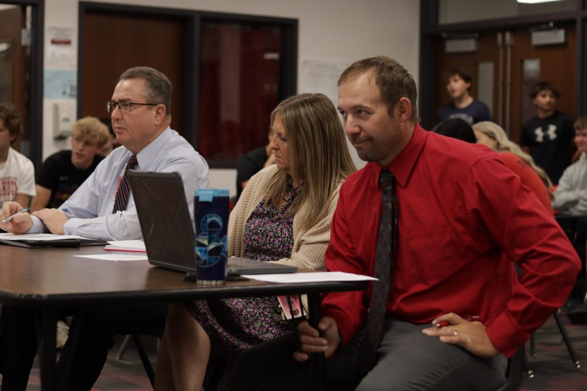 Superintendent Rex Pfeil, principle Stefanie Novotny and government teacher Dan Krajicek judge the mock presidential debate. Krajicek invited administration to add an element of surprise for the candidates. 