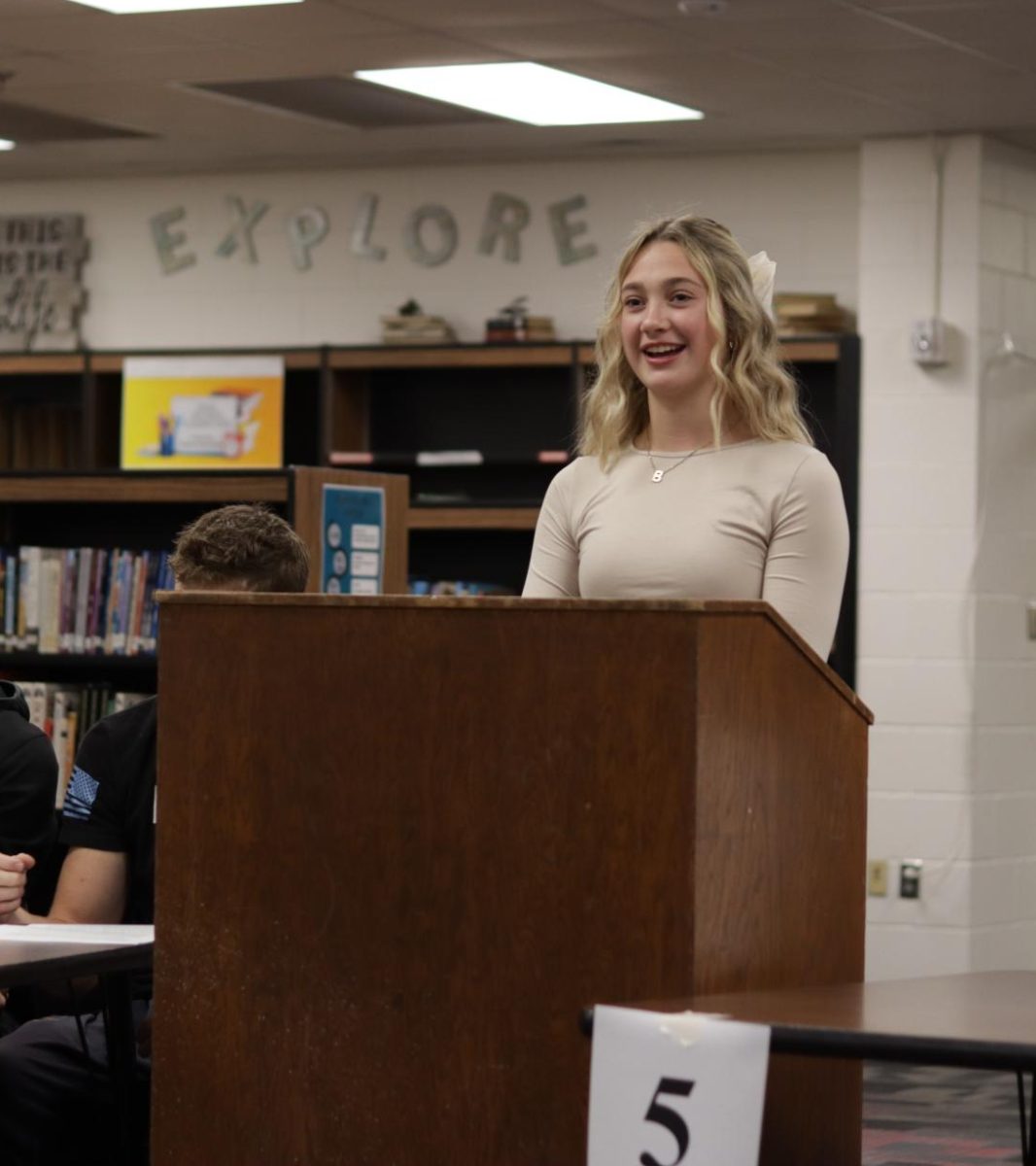 Senior Britney Zeleny takes the stand to give her presidential speech. Each of the candidates had to prepare a speech to sway the votes of students and staff.