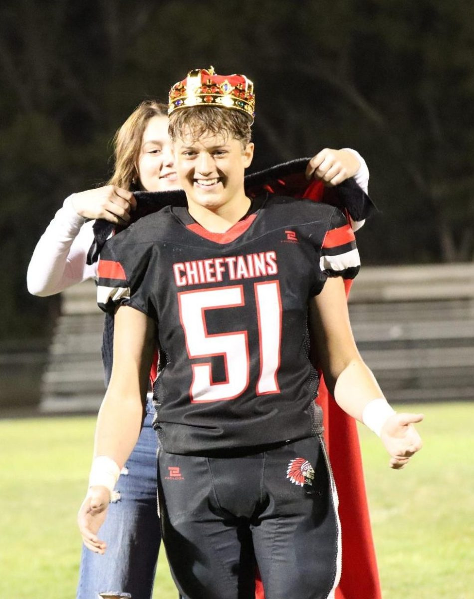 Bennett Ell receives his cape and crown after his football game. Ell was crowned by the 2023 homecoming queen Maura Tichota.