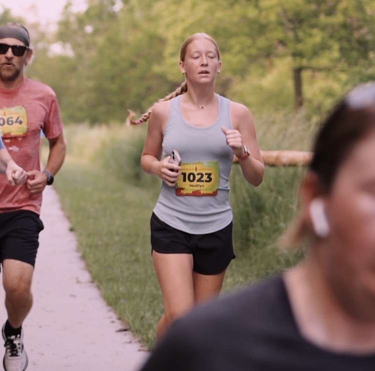 Junior Madi Ledden running during the Cornfield Cornfield 10k. The Cornfield Cornfield 10k took place at Werner Park and Prairie Queen Recreation Area, Nebraska. 