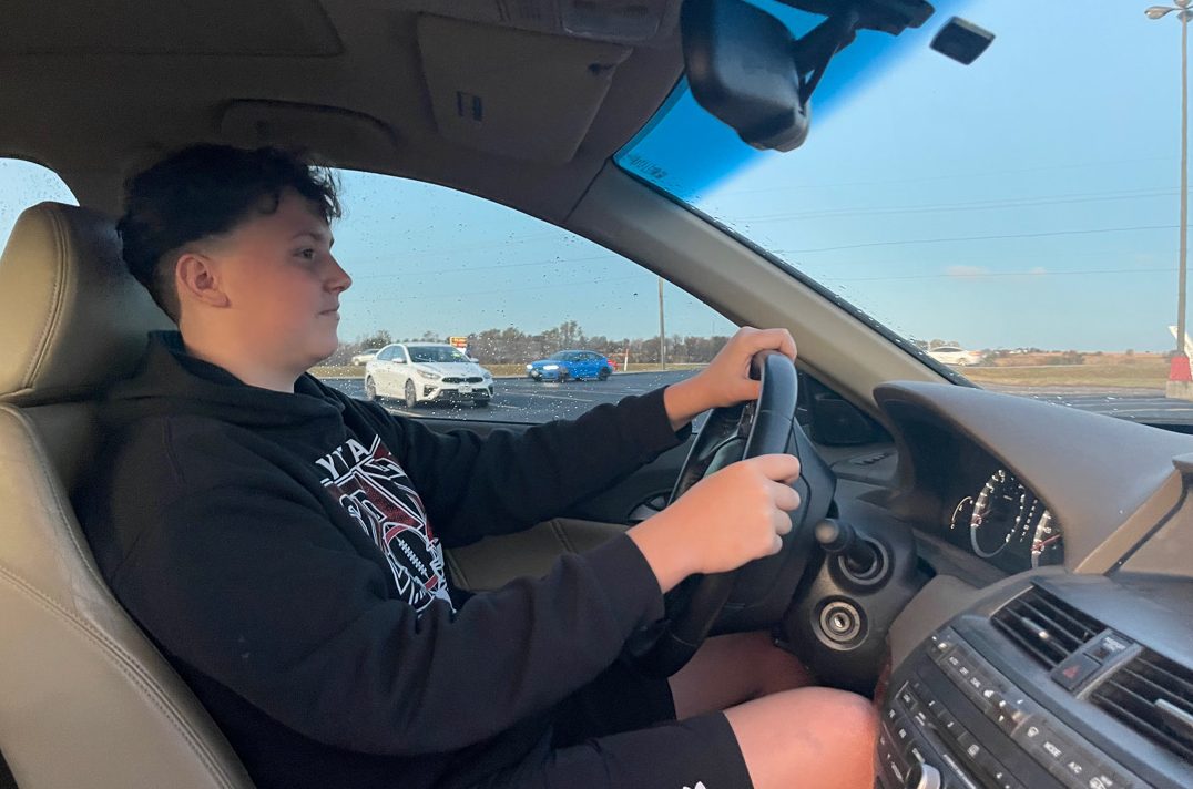 Freshman Chase Schake parks his car in the school parking lot after driving to school. Schake started driving when he was 14.