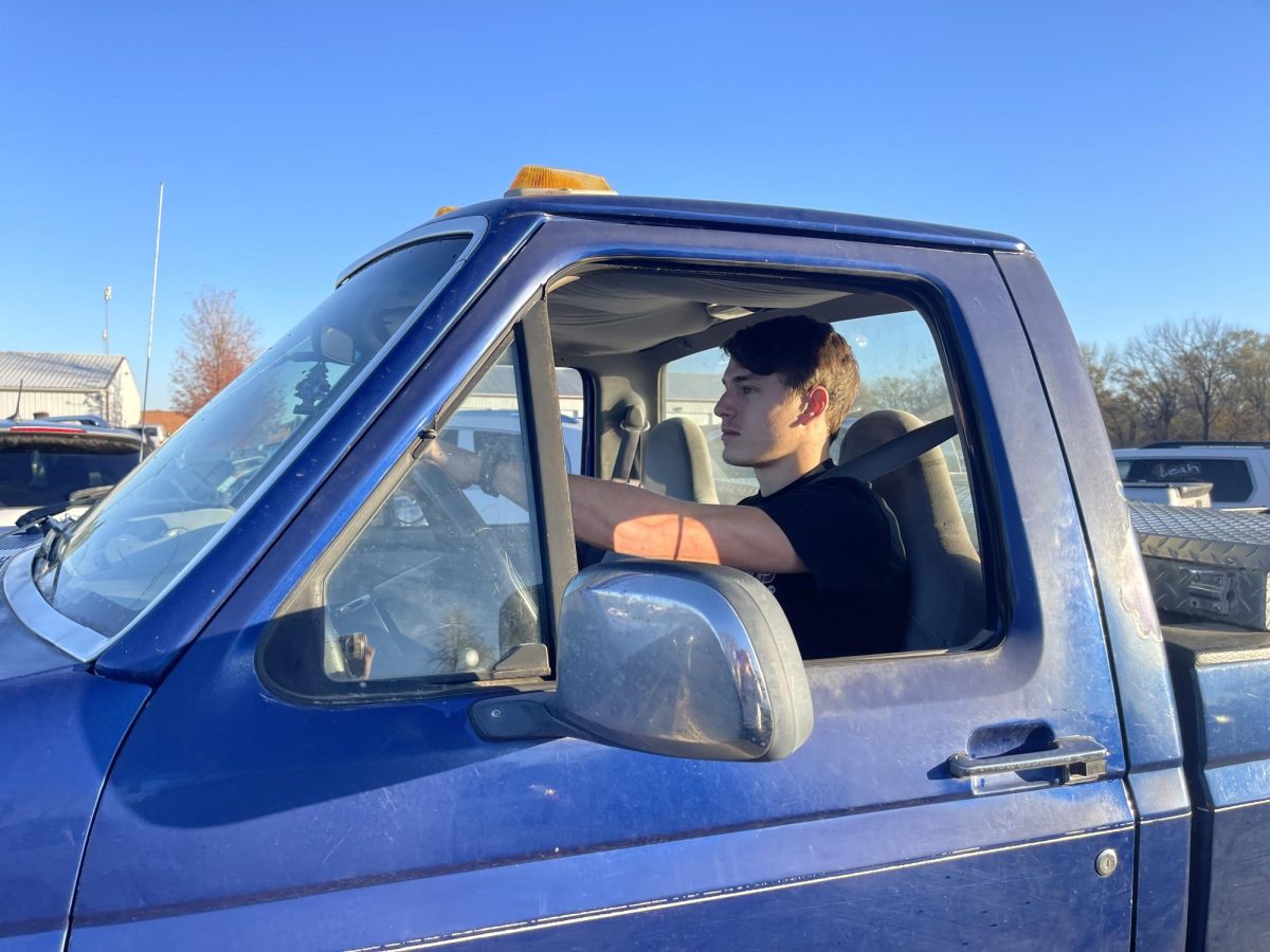 Senior Jason Neukirch pulls out of the high school parking lot. Neukirch's favorite thing about driving is the freedom it brings. 