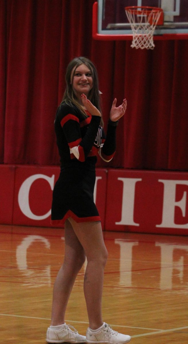 During the 2022-2023 season, sophomore Libby Winn cheers on the boys basketball team. Winn's favorite sport to cheer for is boys basketball.