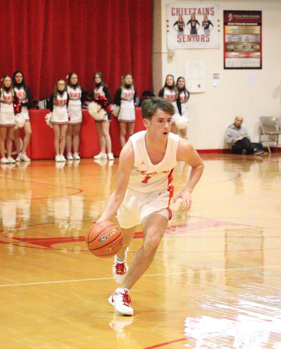 Junior Carson Jurey dribbles the ball up the court. Jurey scored 12 points in this game against Elmwood-Murdock.