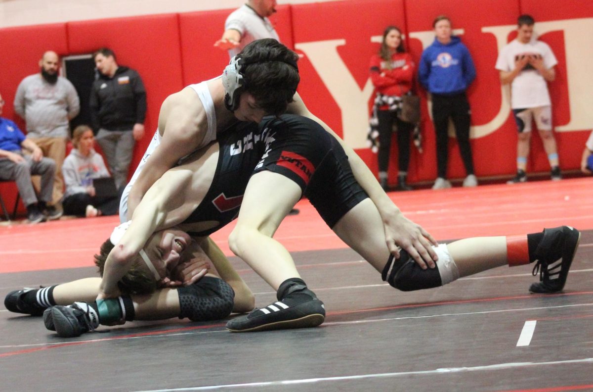 During his freshman year, Drew Krajicek looks for a pin against his opponent. Krajicek's favorite part about wrestling was being able to get close to his teammates on Saturday meets. 