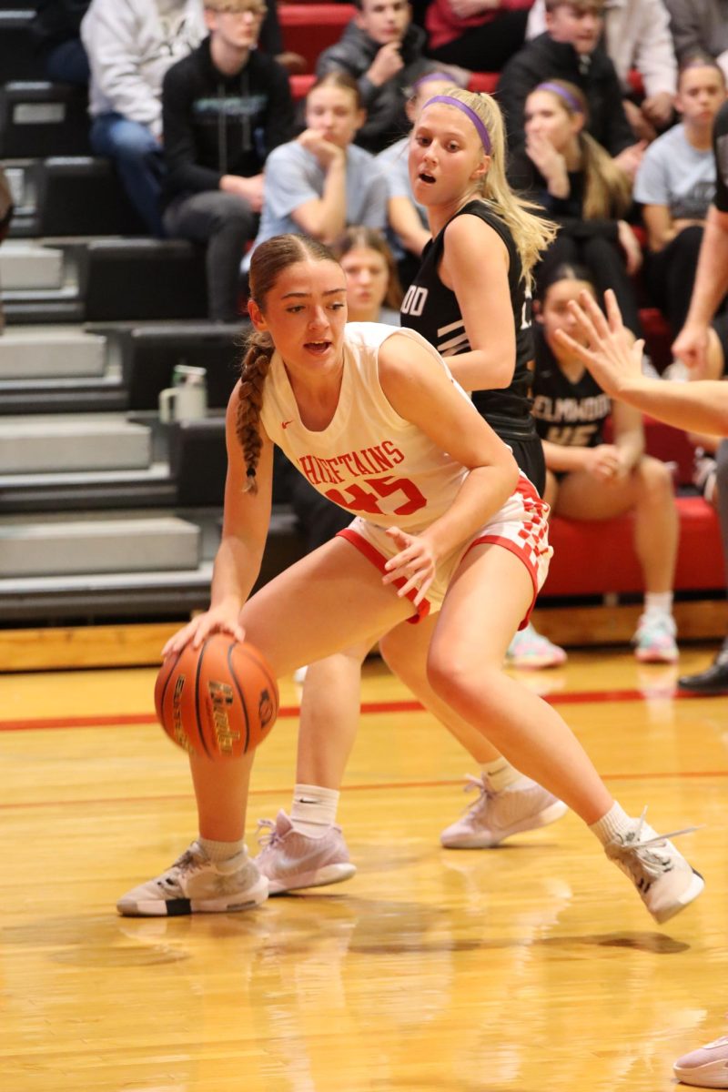 Senior Millie Dieckman drives in to the basket during the Elmwood-Murdock game. Dieckman scored a total of 12 points during the home opener. 