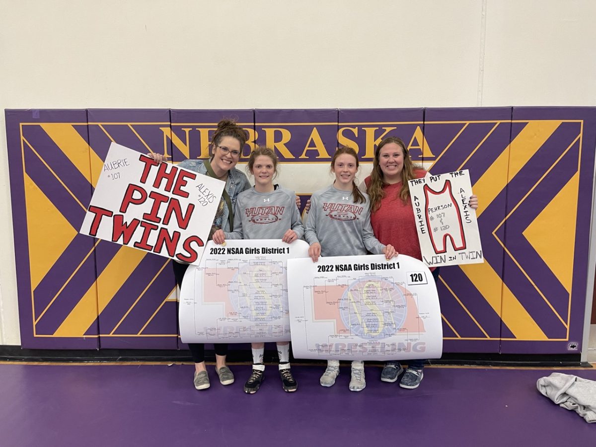 Aubrie and Alexis Pehrson pose for a photo with their aunts after districts freshman year. This is when Aubrie and Alexis were first named the "Pin Twins" after their aunts made posters for them.