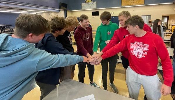 From left to right Nolan Gayer, Gage Kolc,  AJ Arensberg, Clark Cogdill, Lincoln Hoffart, Peyton Reed and Tannen Honke get ready for their first competition at Raymond Central this season. The team shows how connected they are as a whole.