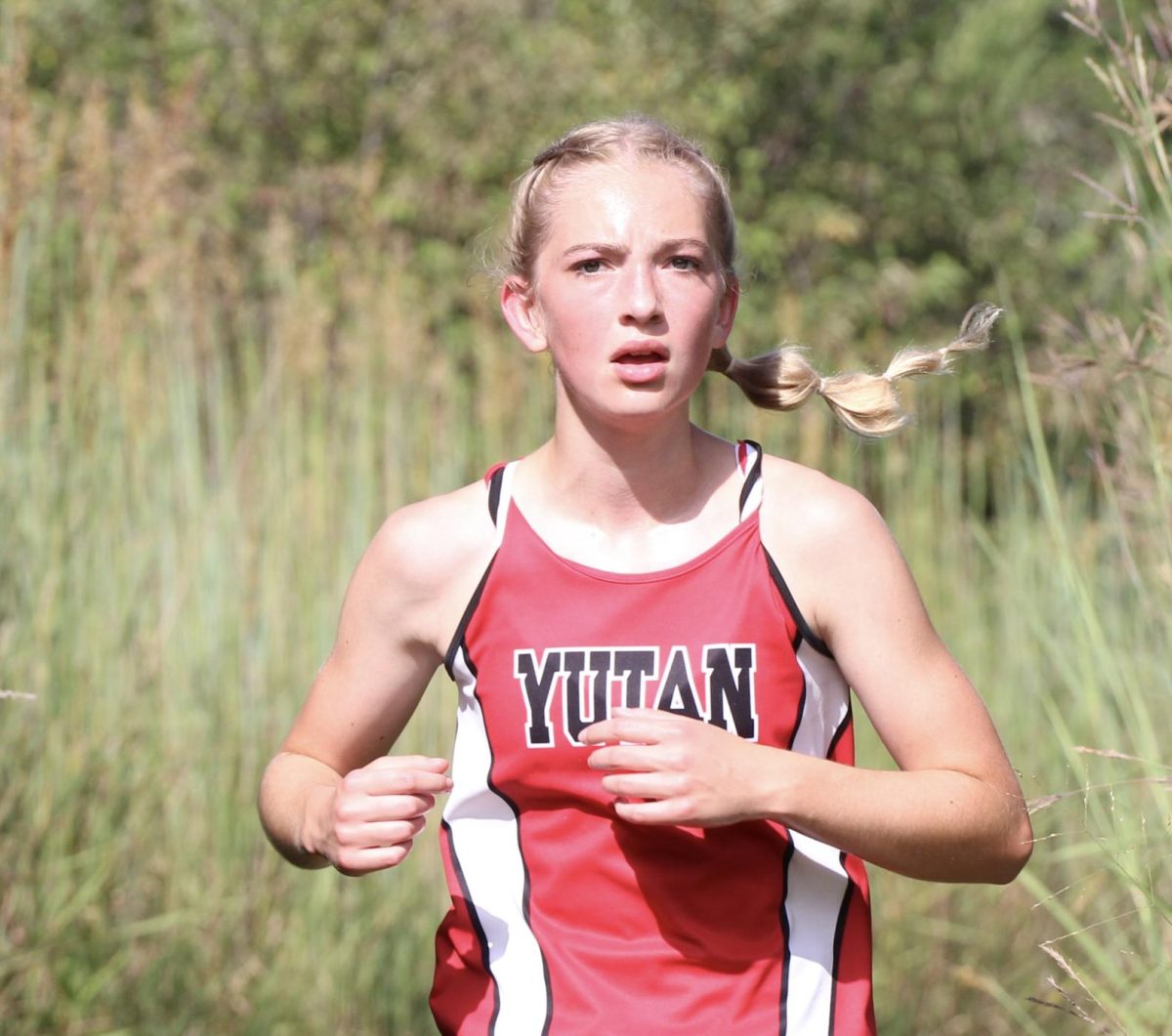 Freshman Audrey Dieckman races down the trail at the East Butler meet. This was Dieckman's very first cross country meet.