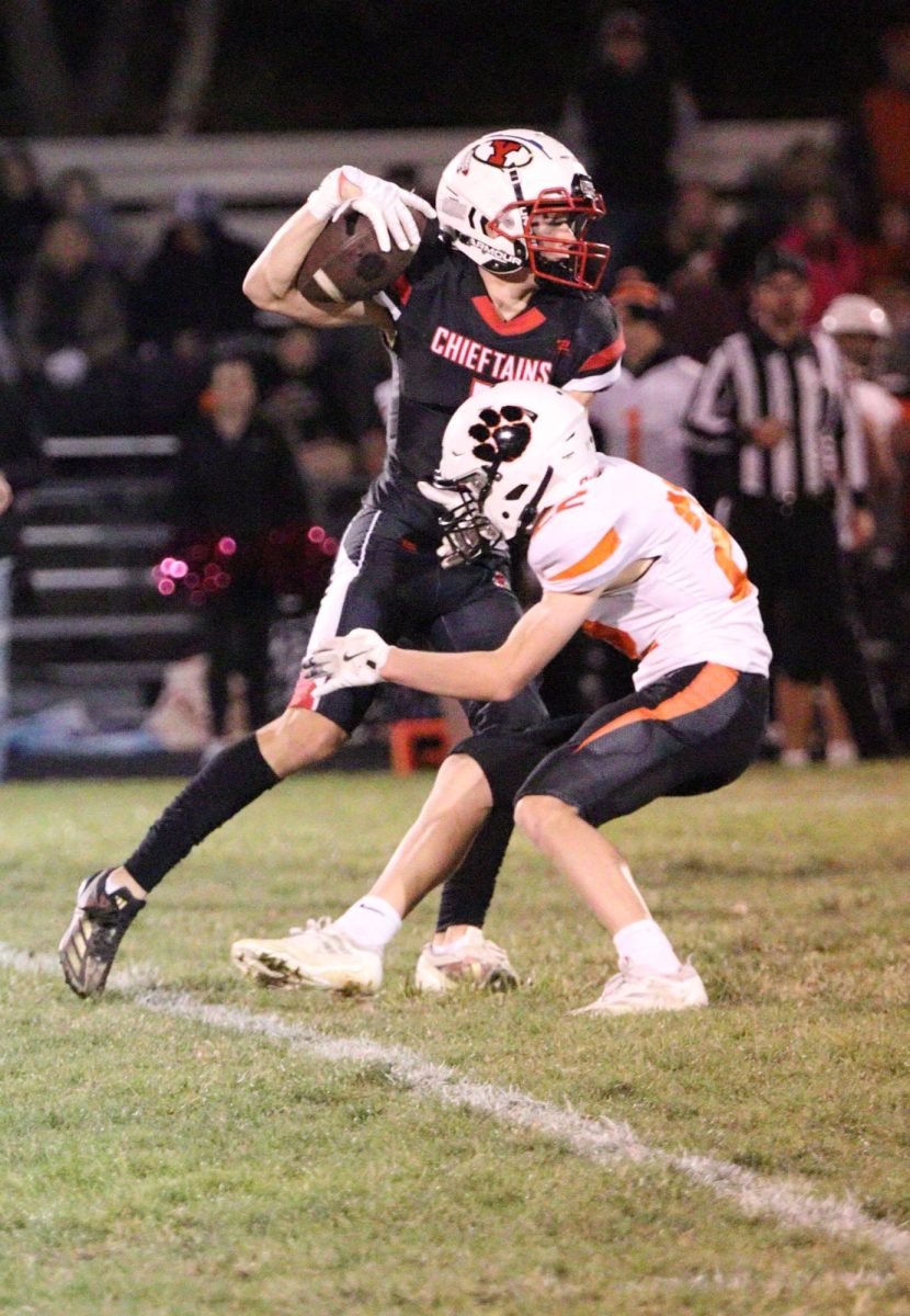 At the very last football game of the season, senior Owen Egr drives through an opponent. The team won against North Bend 57-0.