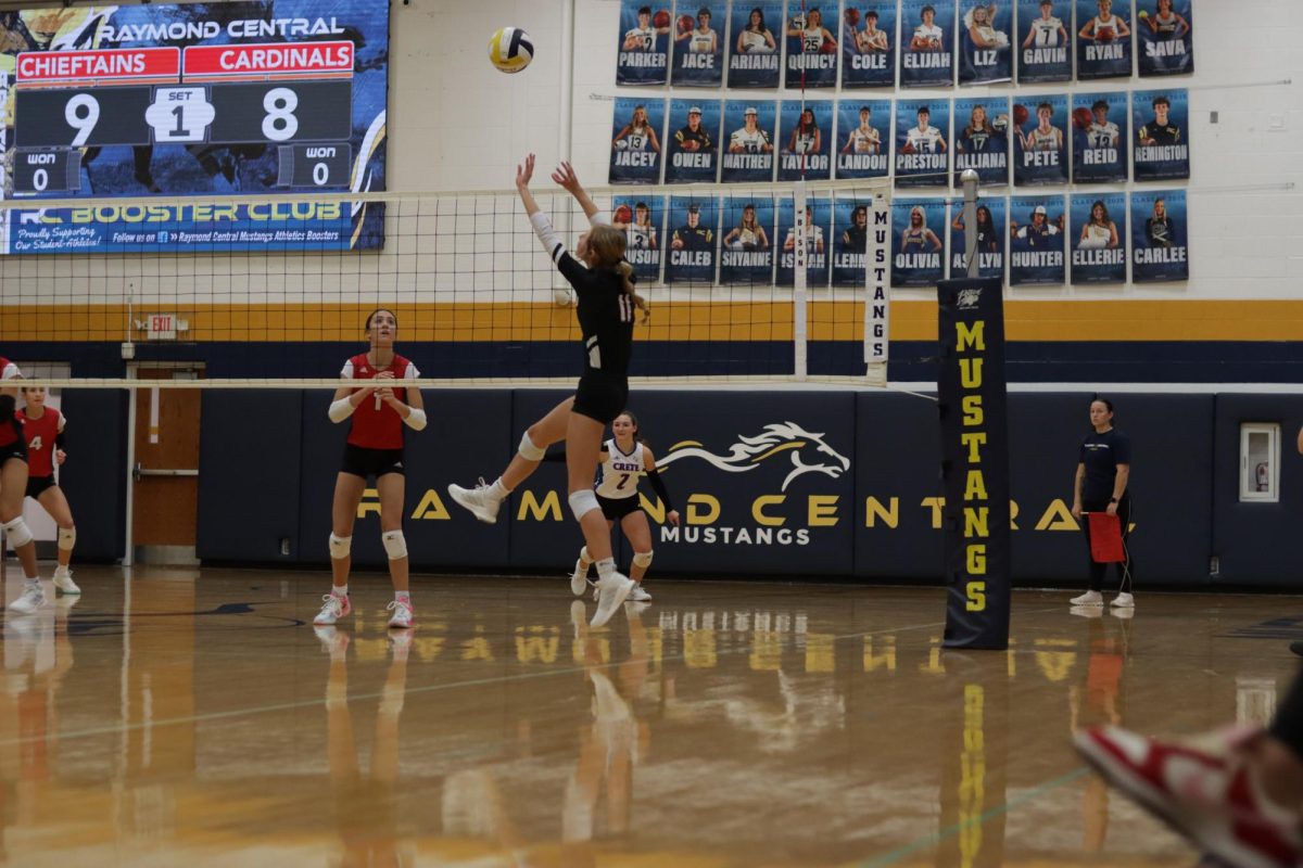 Senior Mckenna Jones sets to a hitter at the Raymond Central triangular. Jones had a total of ____ assists this season.