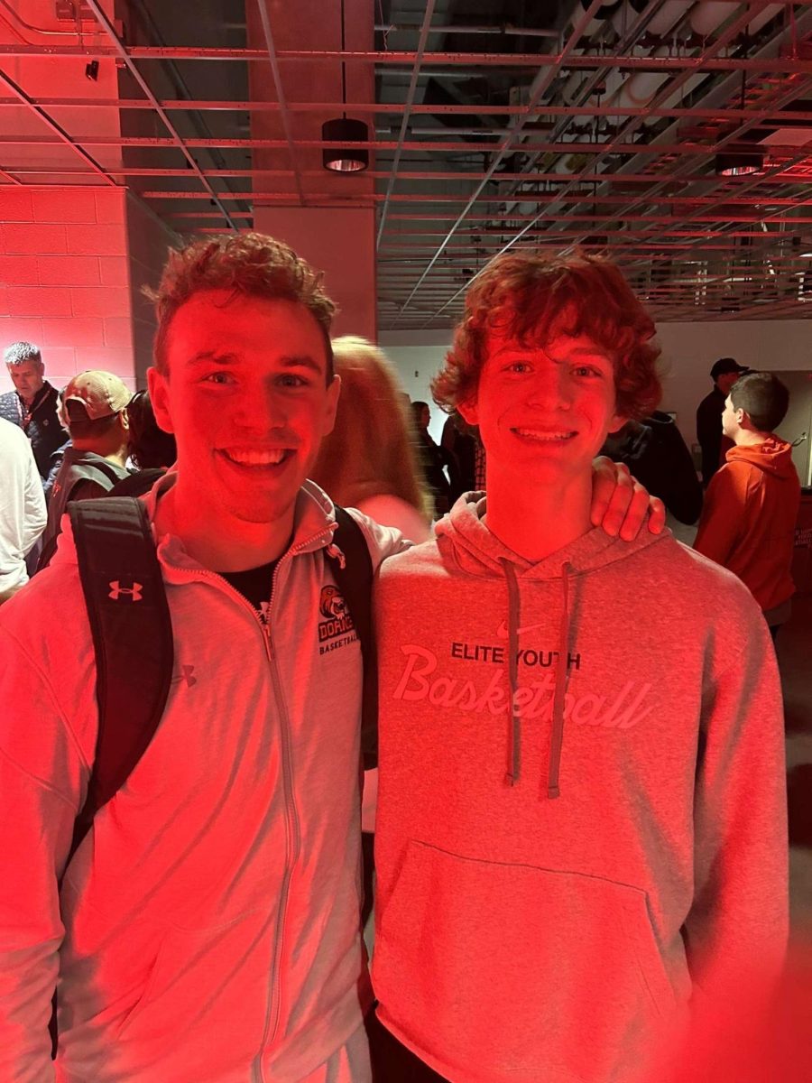 Yutan alumnus Brady Timm and sophomore Ryan Maguire pose for a picture after a Doane basketball game. Timm has been training Maguire for the past two summers. 