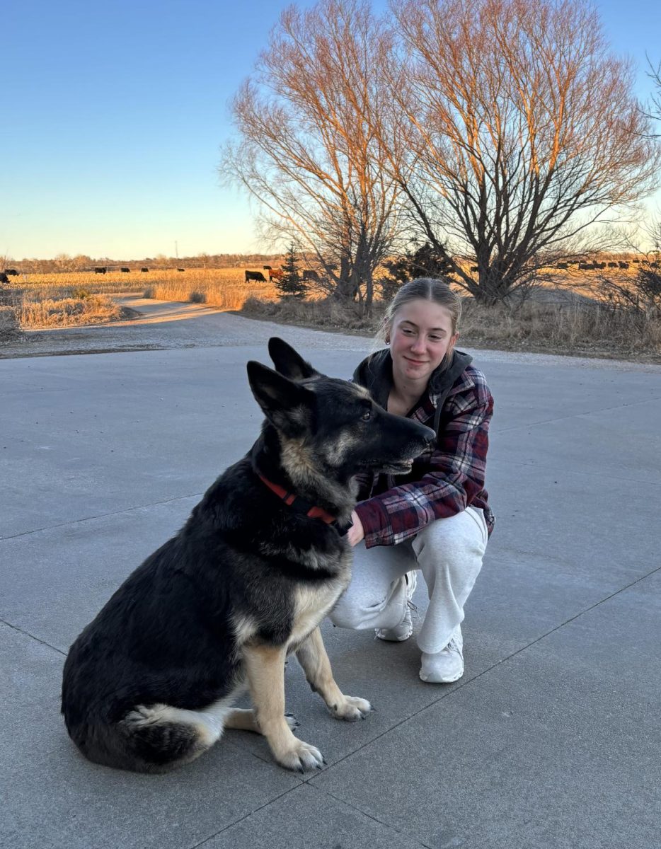 Sophomore Emmy Tederman poses with her German-Shepard dog, Maggie. Tederman has had Maggie for eight years.