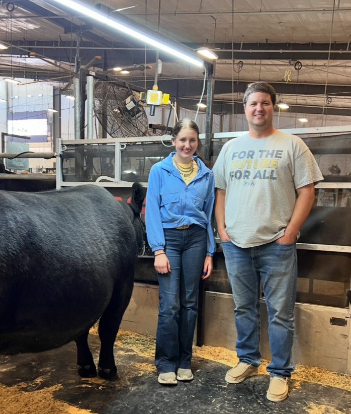 Senior Loganne Barta takes a picture with her FFA advisor, Cole Blomendahl, at the Nebraska State Fair. FFA has enabled Barta to show her cattle during the FFA-only week of state fair every year. 