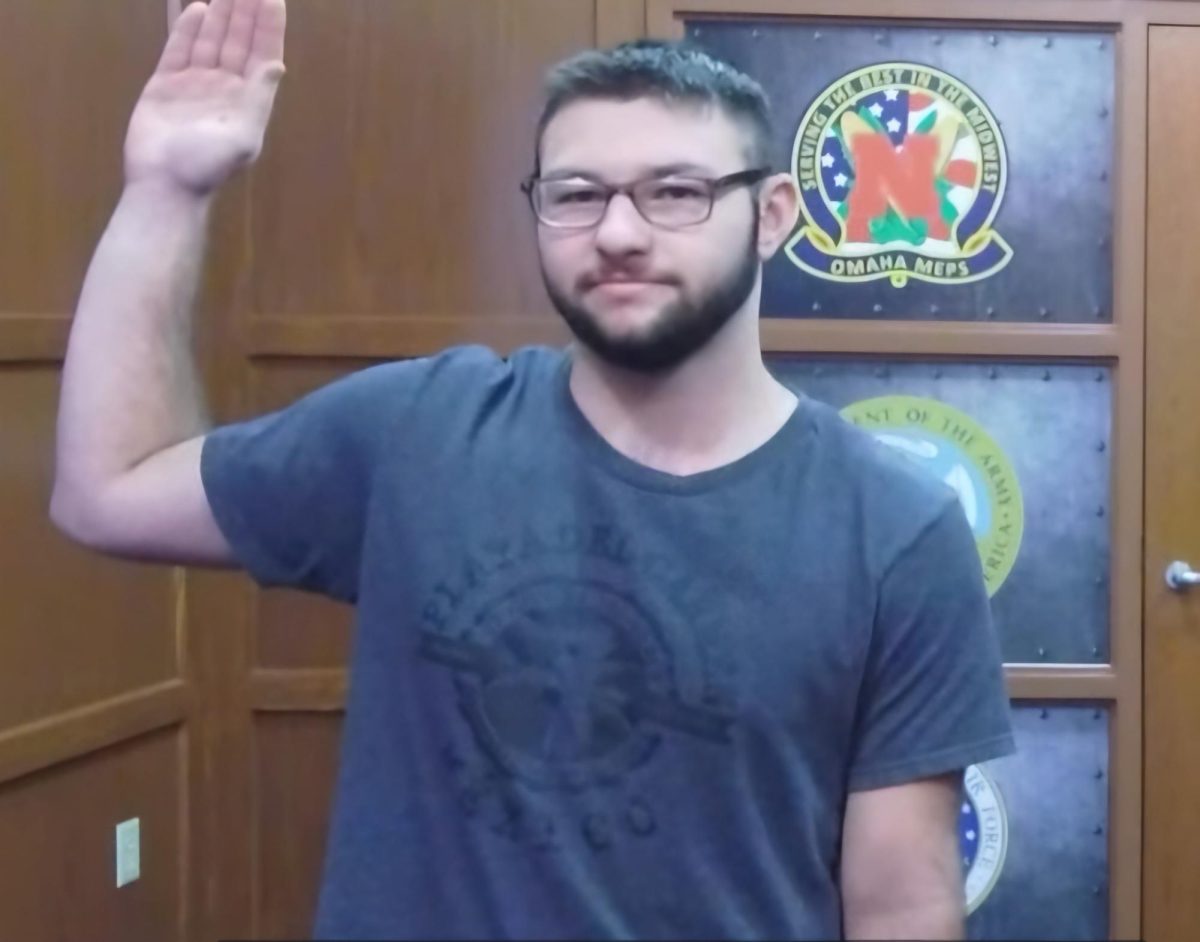 Senior Ian Dunn raises his right hand as he swears into the Air Force. This initial swear-in happened after Dunn completed his tests, but he will have to swear in again around August.