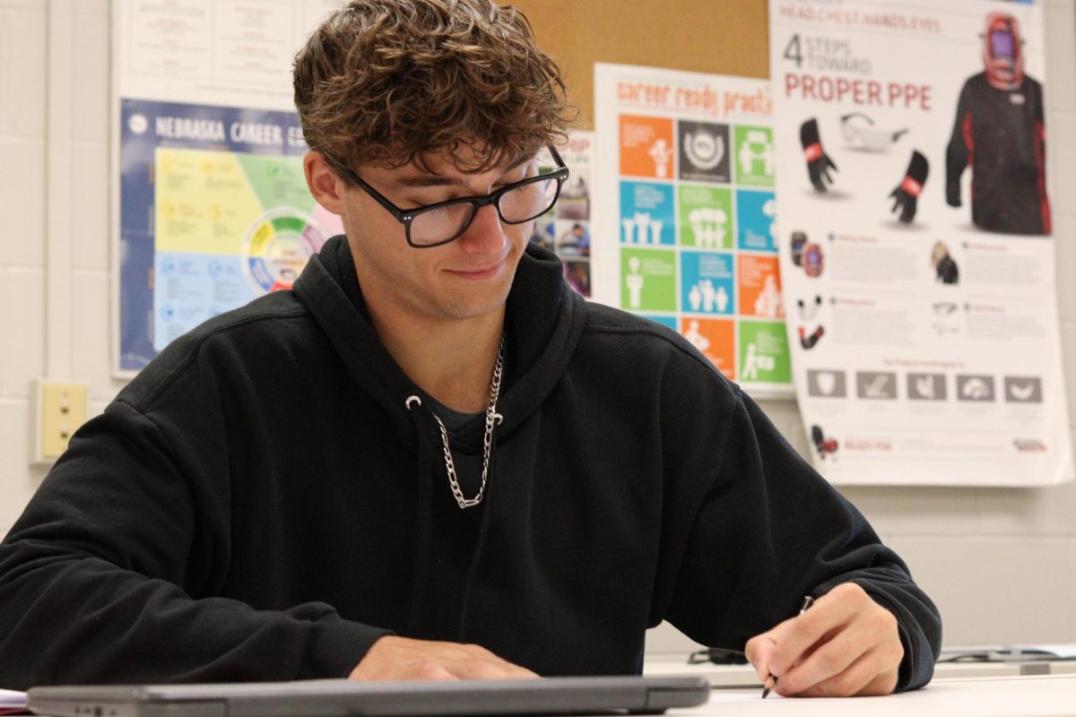 Senior Lucas Bussing works on a paper in his shop class. Bussing hopes to go into mechanics straight out of highschool.