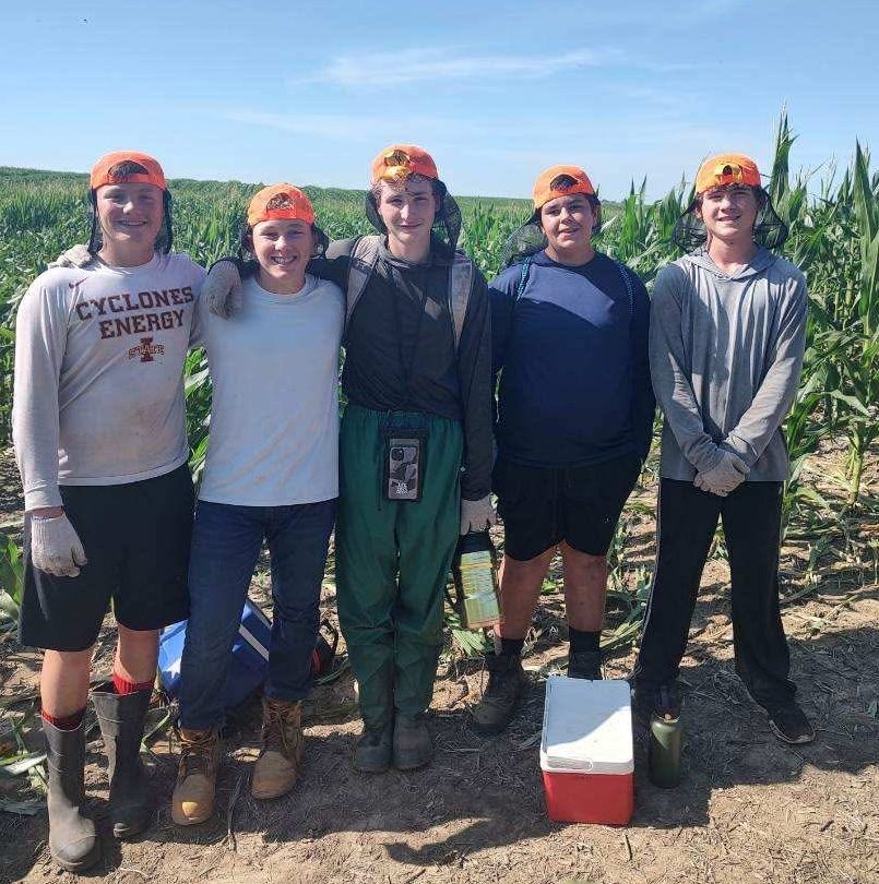 Students Jackson Benjamin,  Colton Sake, Myles Anderson, Logan Shearer, Abel Kraft, pose for a picture after a long day of work. This was the seventh graders' first year, and Myles Anderson's third year detasseling for Glock Detasseling.