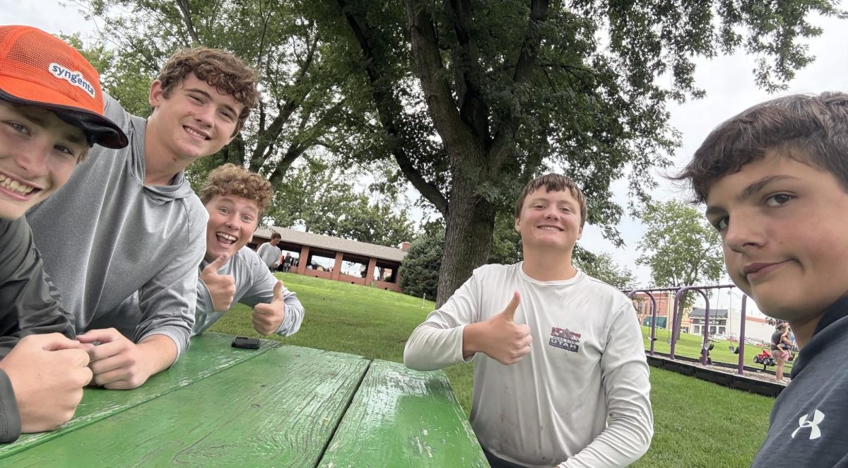 Ninth grader Myles Anderson and eighth grade students Jackson Benjamin, Colton Sake, Alec Wacker, Abel Kraft, pose for a picture during a break in detasseling. 