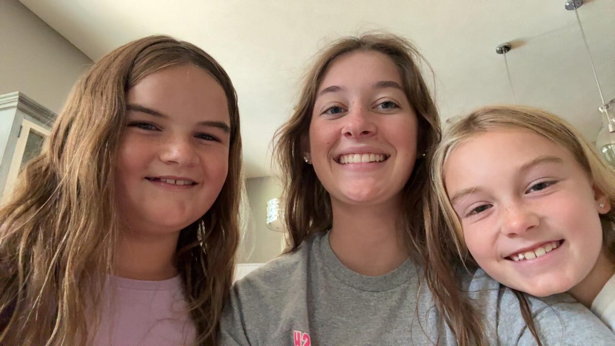 Fifth grader Anna Wilke, senior Anna Rupp and third grader Ruby Wilke pose for a photo after swimming all morning. This was Rupp's third summer babysitting the Wilke girls.
