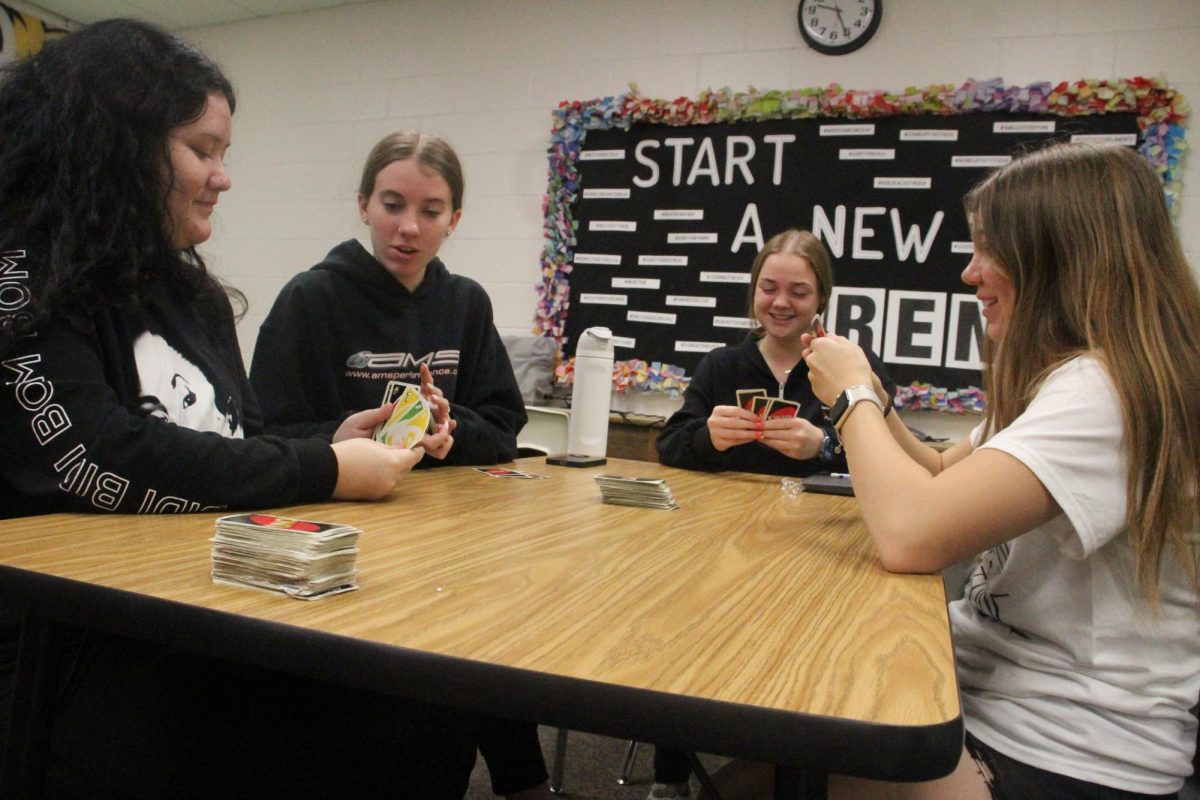 Ruby Ochoa, Molly Besch, Addi Smith and Avery Schmidt play a game of UNO on ________ Tuesday. The FCS class room was one of the few where the lights were working during the power outage.