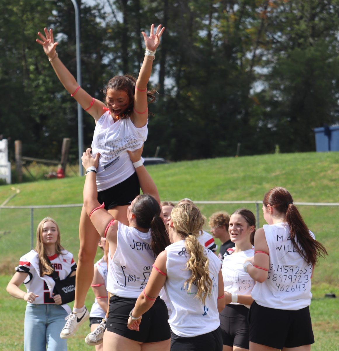 As the seniors gather together after defeating the juniors in powderpuff, Jenna Trent lifts Jenna Benjamin in celebration. The seniors also won the inaugural powderpuff game last year. “It was fun to win for two years in a row, especially after beating the seniors last year; we showed our dominance,” Trent said.