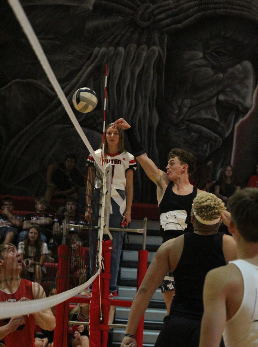 During a challenging game of powderbuff volleyball, junior Ryan Maguire hits the volleyball over the net. Maguire was part of the junior team that lost in a close game against the senior team. “The most fun part of powderbuff was dressing up with my friends and talking trash to the other team,” Maguire said.